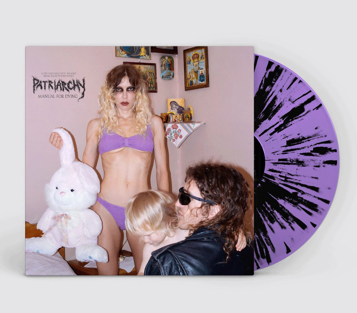 Vinyl record with a cover featuring a person in lingerie holding a plush toy, with a purple and black splatter design on the side.